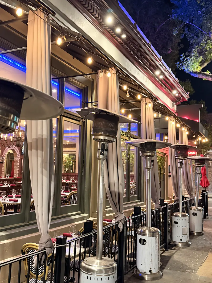 The patio on Main Street, with heaters and string lights